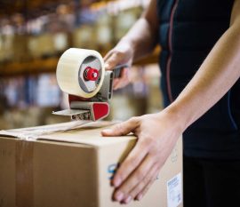 male-warehouse-worker-sealing-cardboard-boxes-PSKUTTE.jpg